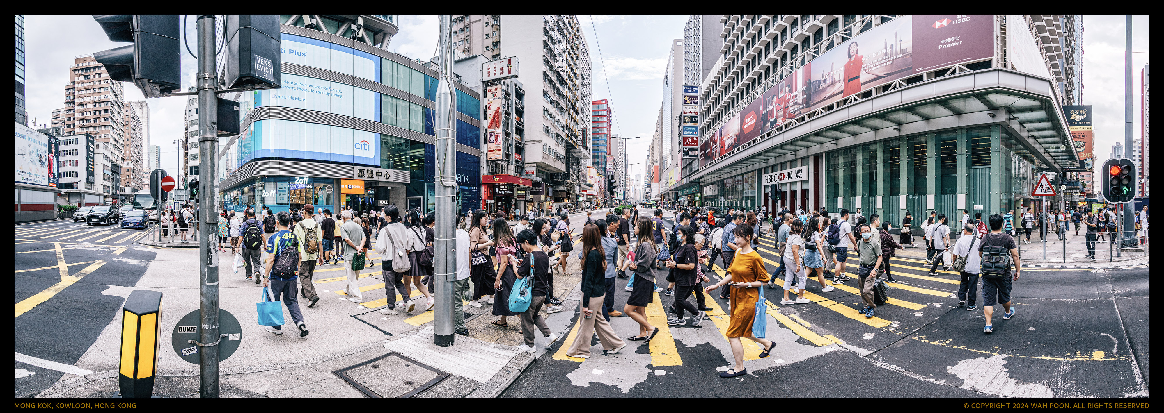Ultra wide angle panoramic view of pedestrians crossing the road in Mong Kok, Kowloon, Hong Kong, captured at a 220-degree field of view.